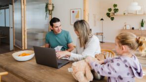 young parents calculating and managing family budget while sitting at table with laptop at home