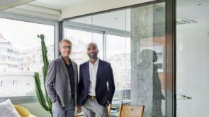 Business partners smiling standing together in an office