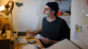 A small business owner working on their taxes from their home office