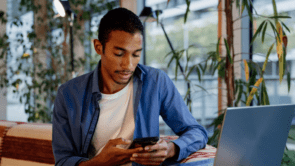 a young adult using his phone