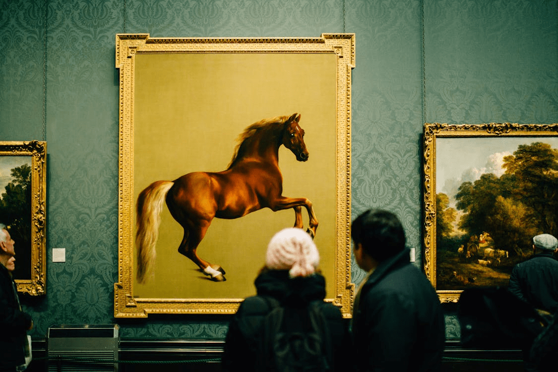 People observing fine art in a gallery