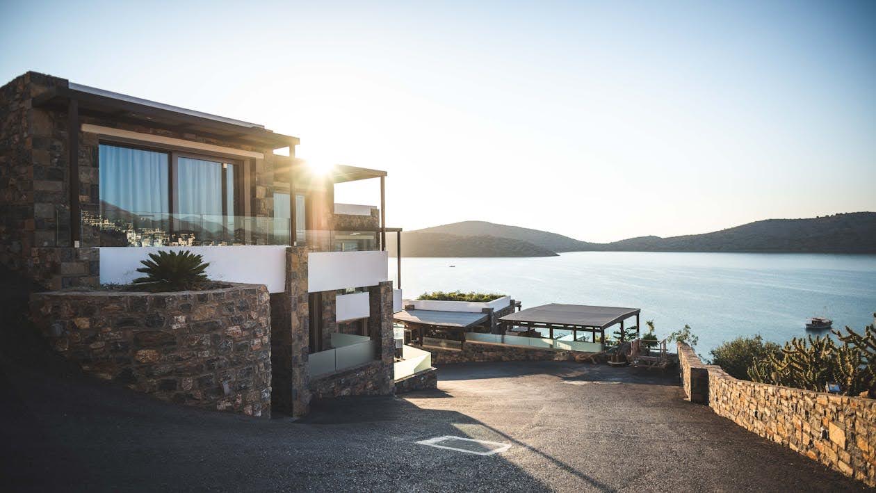 A modern waterfront mansion made of glass and stone