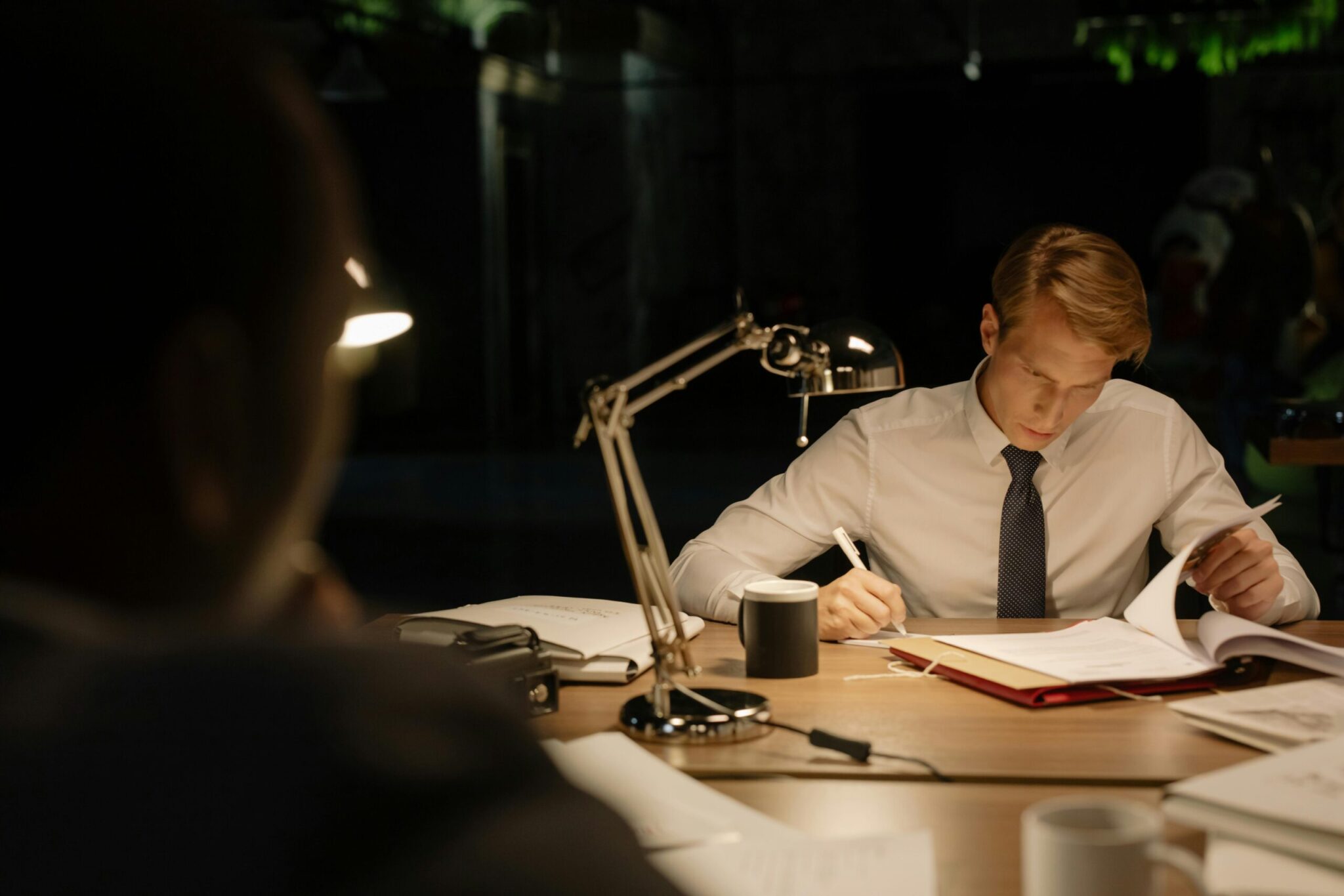 A tax advisor reviews paperwork at a desk—symbolizing the time-consuming manual process of chasing client documents.