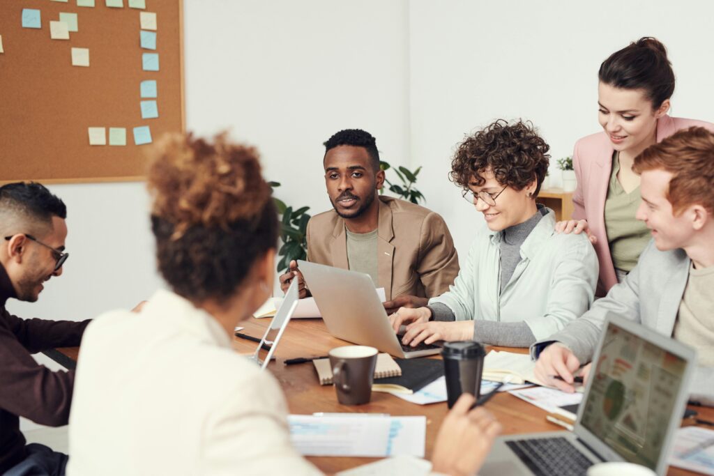 Image of tax professionals sat around a desk with their computers.