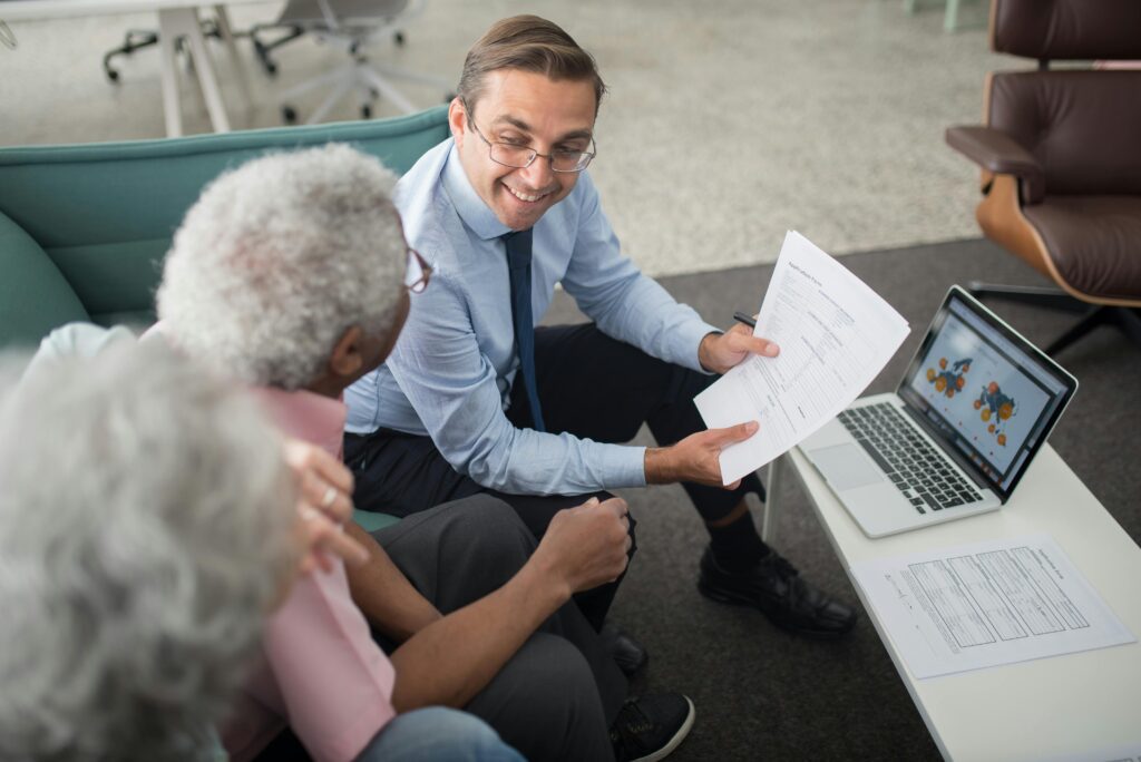 A tax advisor showing documents to an elderly couple