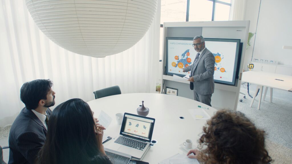 A diverse group of professionals collaborating in an office setting, emphasizing teamwork and cooperation in navigating Section 301 tariff exclusions.