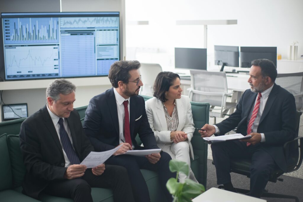 Four professionals collaborating in an office, representing U.S. expats organizing documentation for foreign tax credit filings.