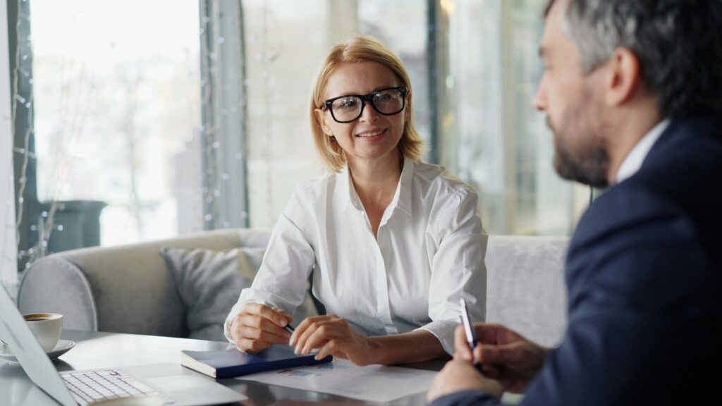 Two professionals discussing tax strategy in a modern office, illustrating personalized expat tax advice for foreign tax credit carryover planning.