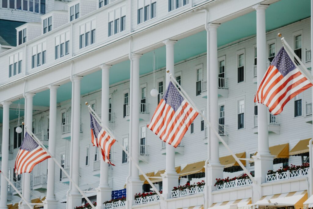 Image of the American Flag being flown outside of a building to symbolize local state laws.