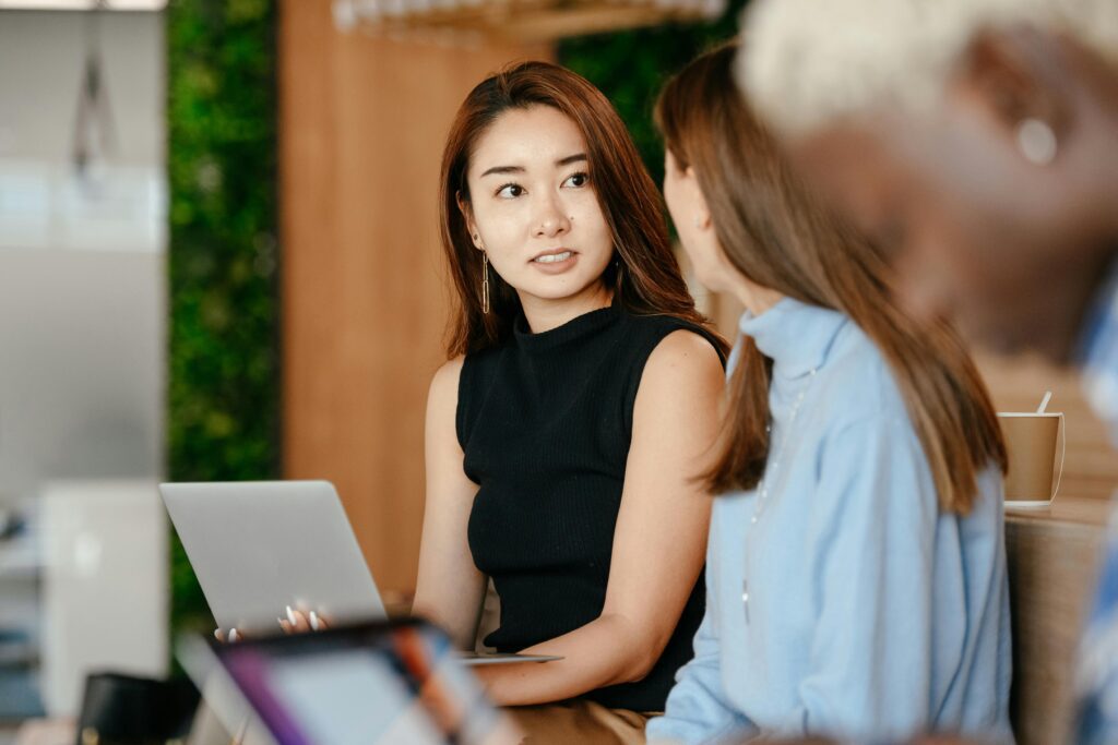 A woman discussing a business plan with diverse colleagues.